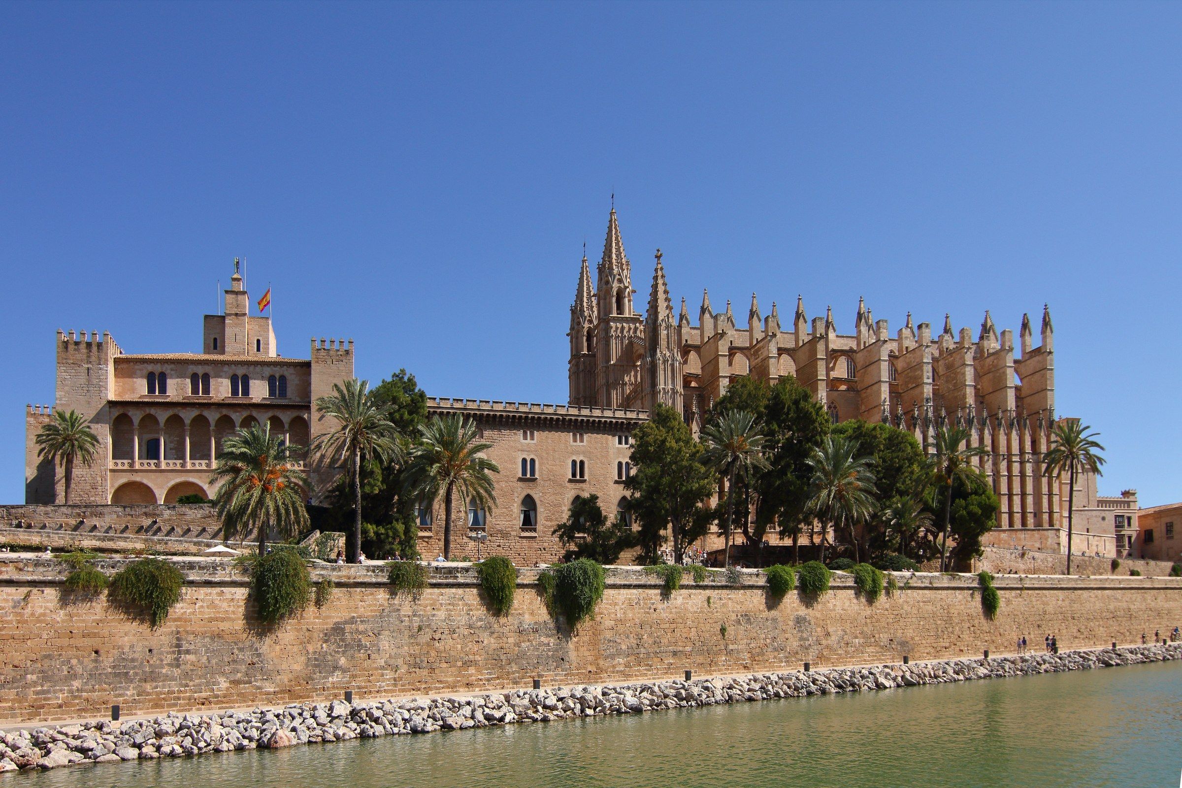 Palma Cathedral (La Seu) and the Almudaina Palace reflected in the pond at the Parc de la Mar